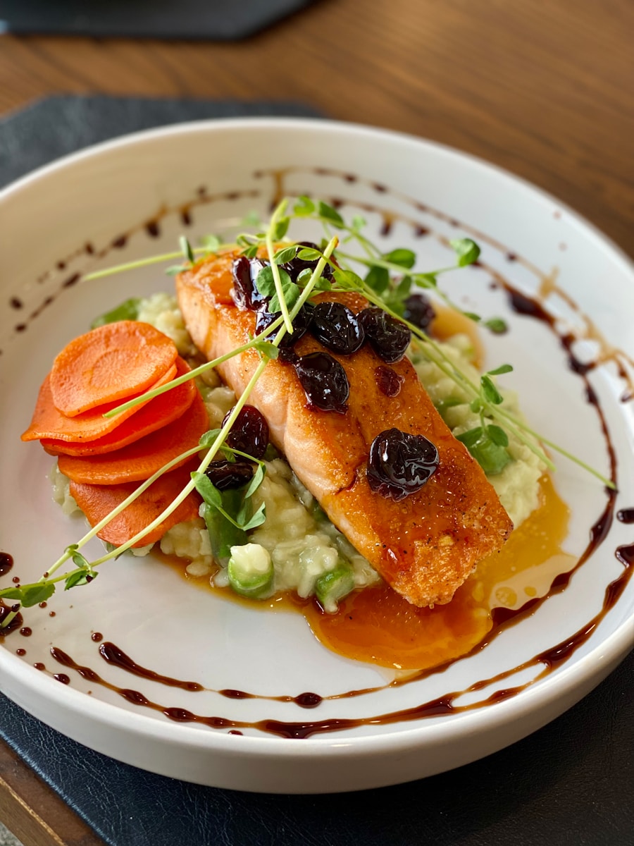 a white plate topped with fish and veggies